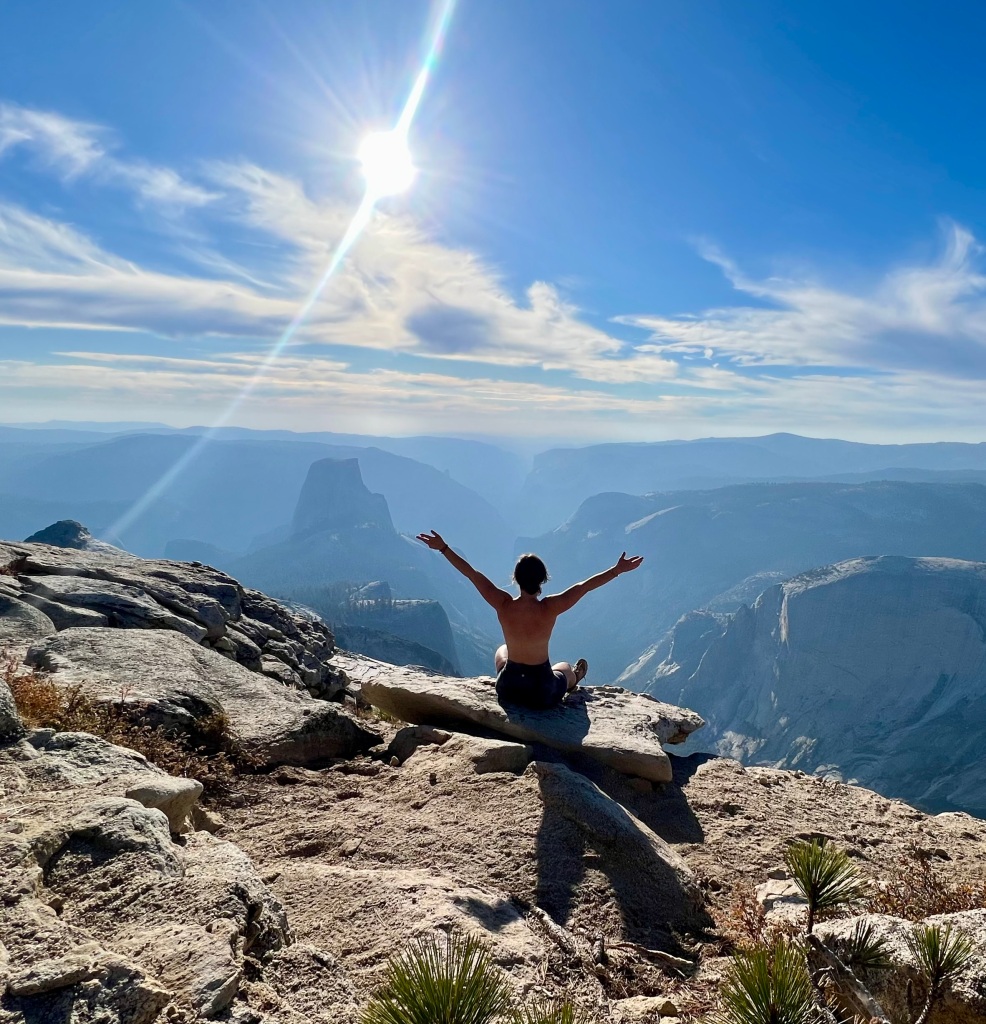 A mindful moment of presence at the top of Clouds Rest in Yosemite National Park